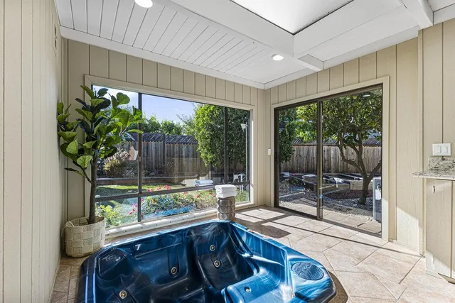 a backyard of a house with dining table and chairs