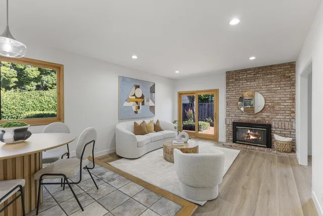 a living room with furniture and a view of kitchen