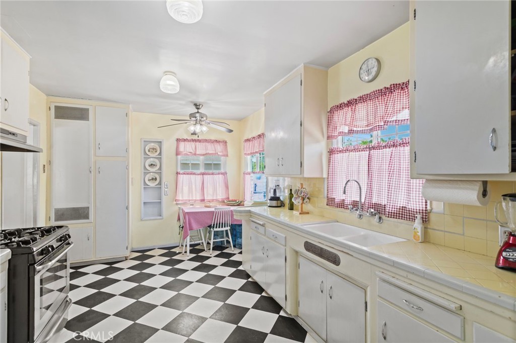 7508 Brookmill Road Downey, CA 90241 - Photo 11 of 29 a kitchen with a sink a stove a refrigerator and a window