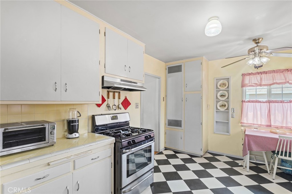 7508 Brookmill Road Downey, CA 90241 - Photo 12 of 29 a kitchen with stainless steel appliances a stove a sink and a refrigerator with wooden floor
