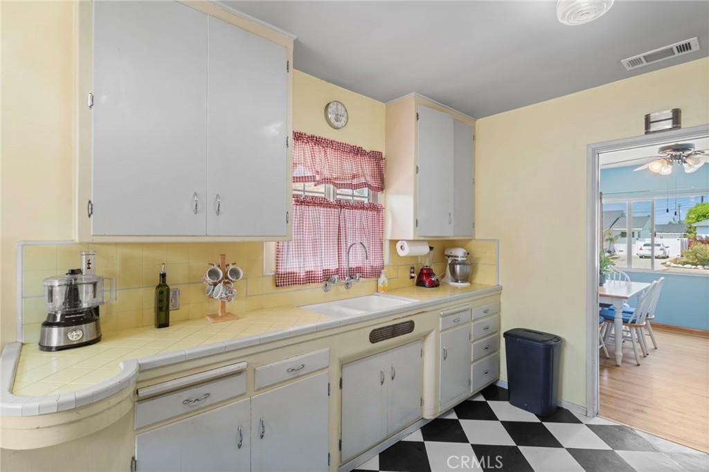 7508 Brookmill Road Downey, CA 90241 - Photo 14 of 29 a kitchen with a sink a stove and cabinets