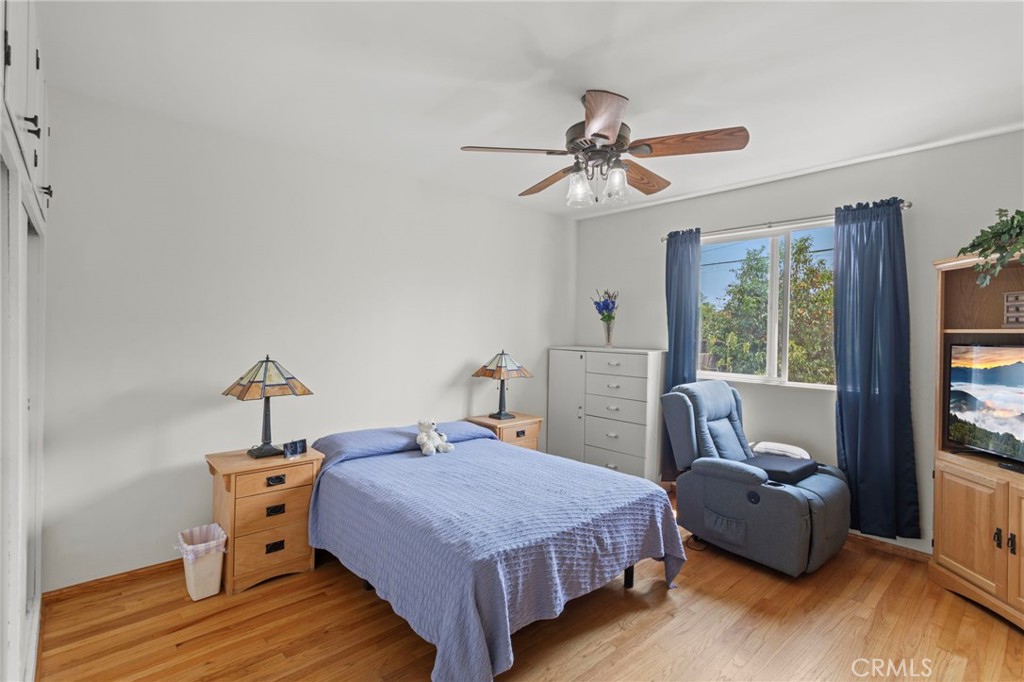 7508 Brookmill Road Downey, CA 90241 - Photo 20 of 29 a bedroom with a bed and wooden floor