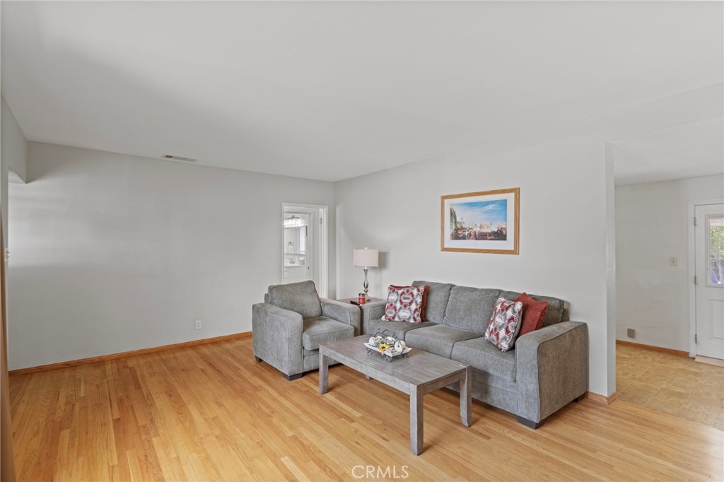 7508 Brookmill Road Downey, CA 90241 - Photo 7 of 29 a living room with furniture and a wooden floor