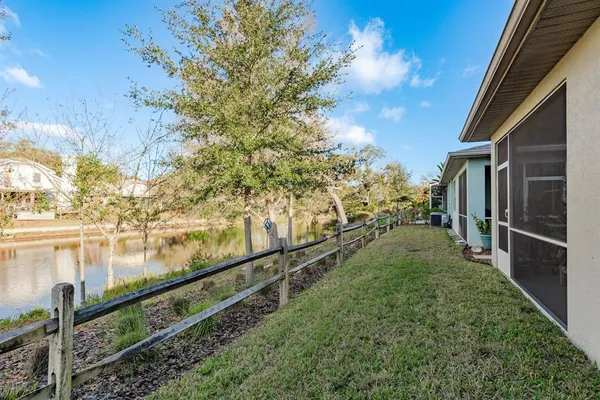a view of a yard with wooden fence