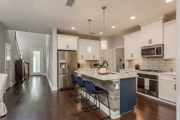 a view of entryway and hall with wooden floor