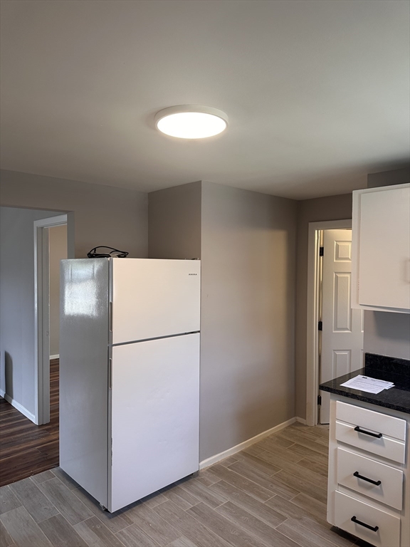 24 Concord Street, Unit 5 Ashland, MA 01721 - Photo 1 of 11 a kitchen with a refrigerator and a stove