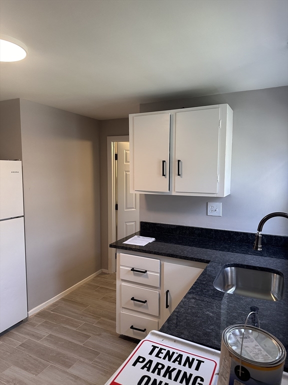 24 Concord Street, Unit 5 Ashland, MA 01721 - Photo 3 of 11 a kitchen with granite countertop a stove a cabinets and wooden floor