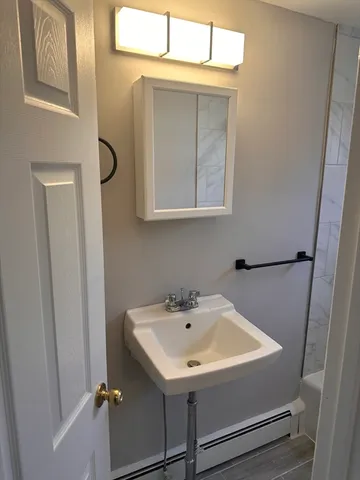a bathroom with a sink and mirror