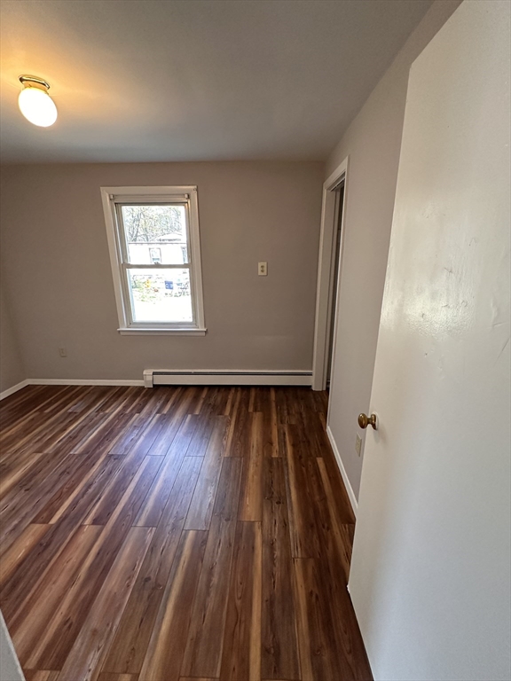 24 Concord Street, Unit 5 Ashland, MA 01721 - Photo 9 of 11 an empty room with wooden floor and windows