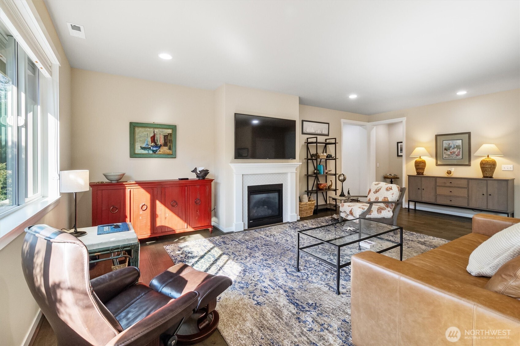 2712 Coho Lane Anacortes, WA 98221 - Photo 12 of 34 a living room with furniture a flat screen tv and a fireplace