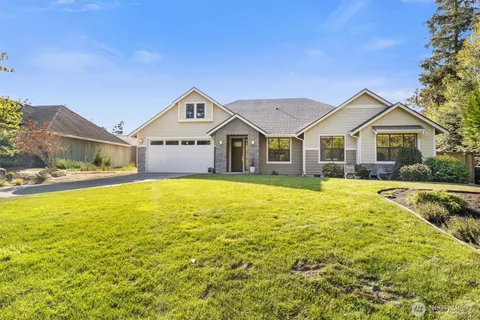 a front view of a house with a yard table and chairs