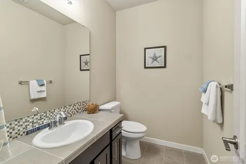 a bathroom with a sink toilet and a mirror