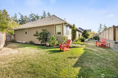 a view of a house with backyard porch and sitting area
