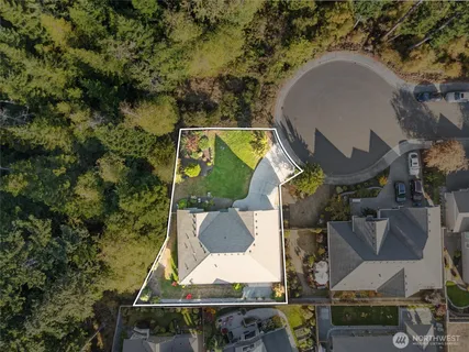 an aerial view of a house with swimming pool and garden