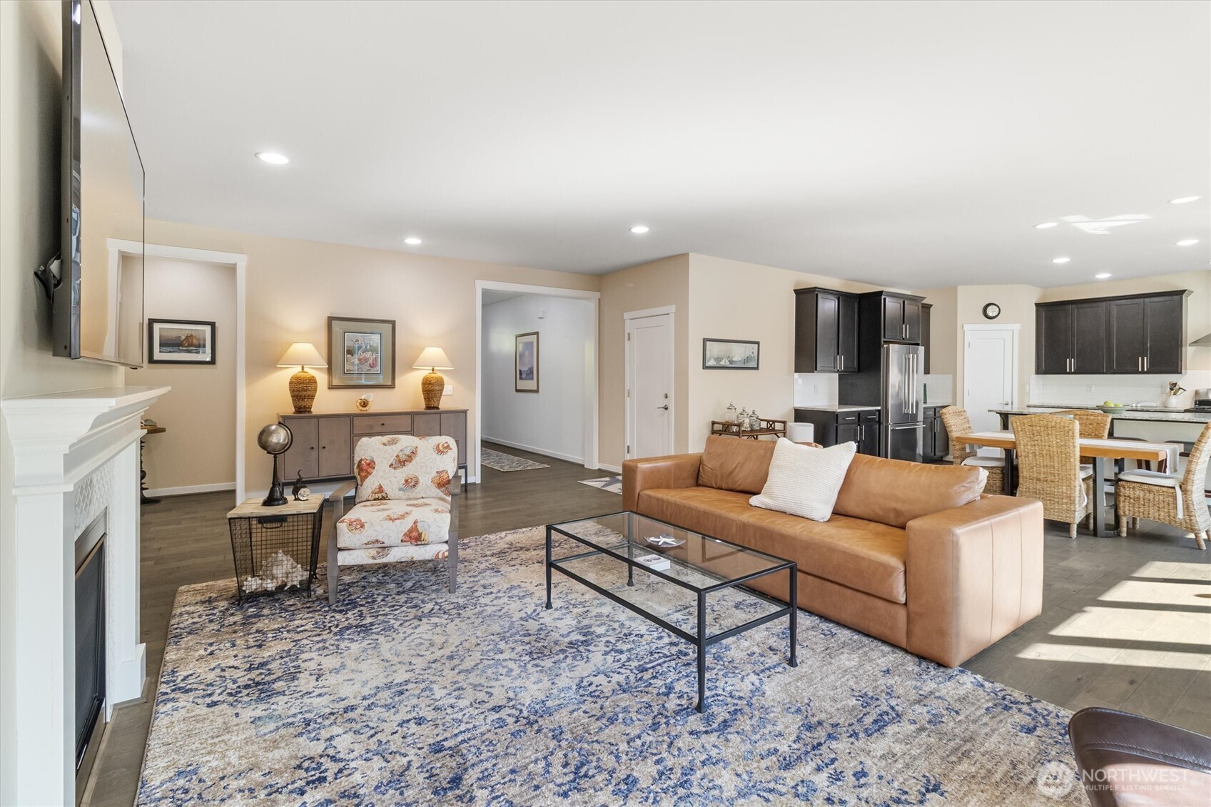 2712 Coho Lane Anacortes, WA 98221 - Photo 10 of 34 a living room with furniture a fireplace a flat screen tv and kitchen view