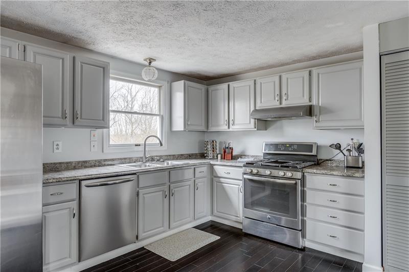 319 Ritter Road South Sewickley, PA 15143 - Photo 6 of 23 Beautiful white cabinetry, all stainless steel appliances, gas stove and pantry are features in this spacious kitchen.