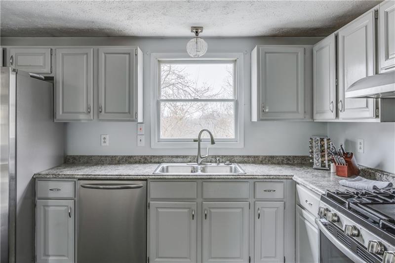 319 Ritter Road South Sewickley, PA 15143 - Photo 7 of 23 Natural light flows into the space and views of the wooded back yard can be seen from the window over the sink.