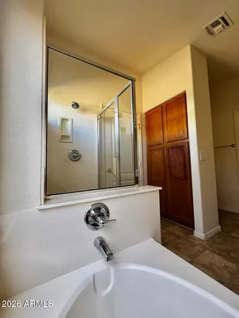 a bathroom with a tub and shower