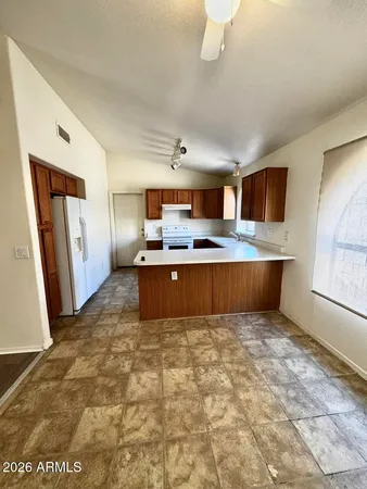 a view of kitchen with refrigerator sink and wooden floor