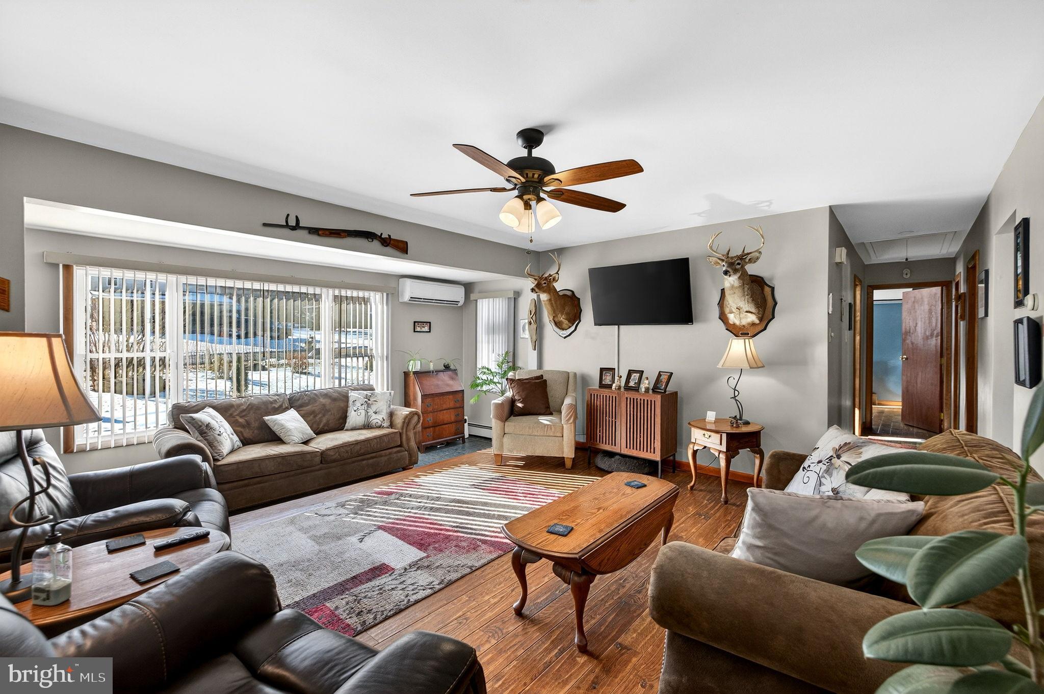 854 Lily Lake Road Wapwallopen, PA 18660 - Photo 12 of 36 Cozy living room with rustic charm.