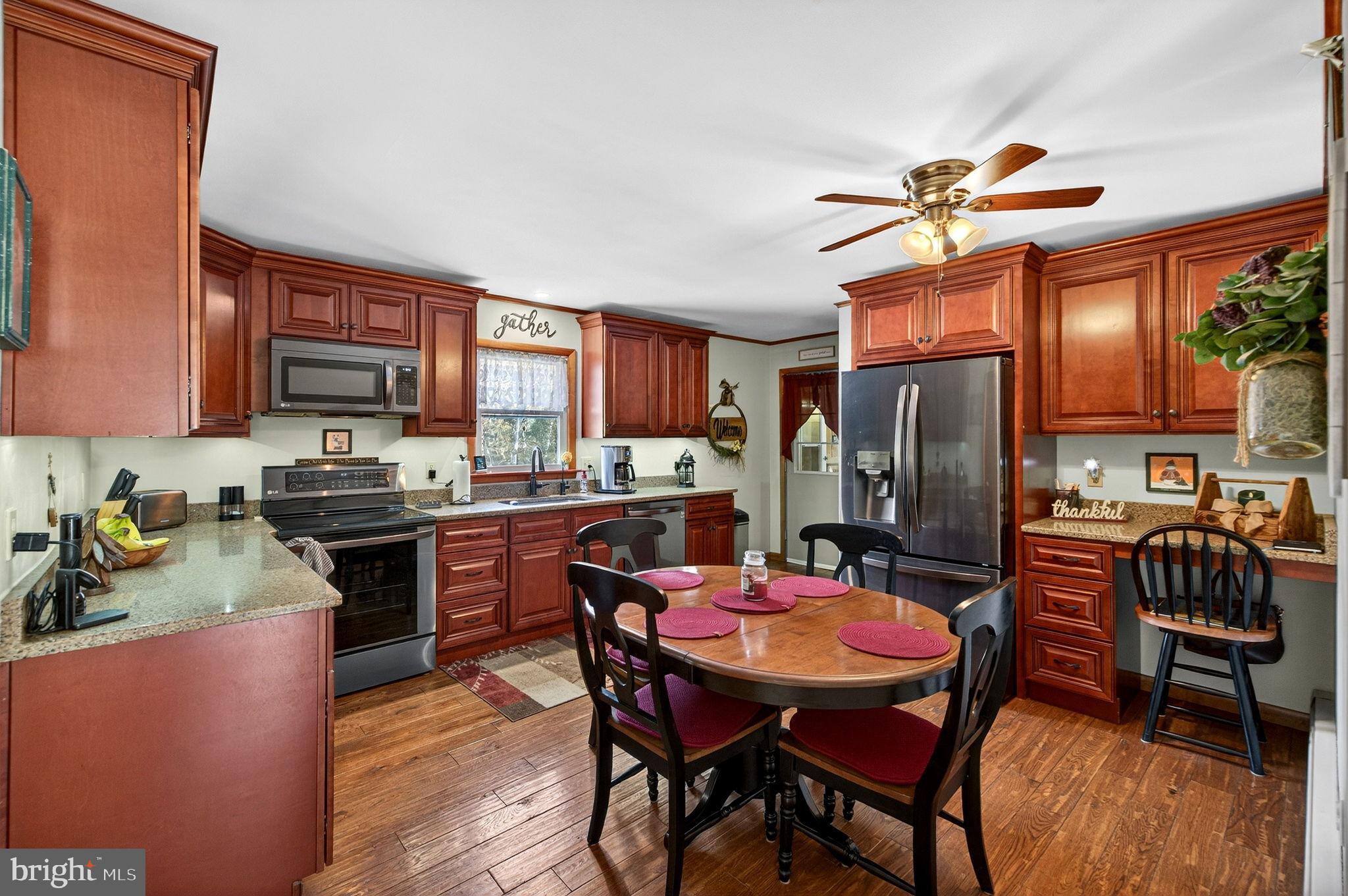 854 Lily Lake Road Wapwallopen, PA 18660 - Photo 13 of 36 Warm and inviting kitchen with rich cabinetry.