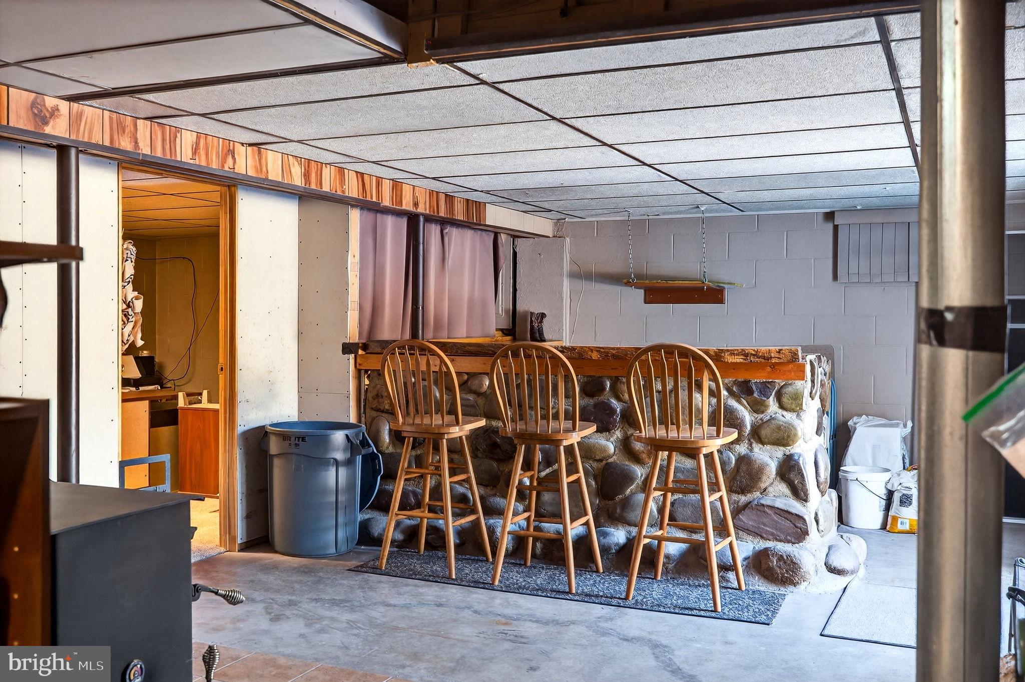 854 Lily Lake Road Wapwallopen, PA 18660 - Photo 24 of 36 Cozy basement bar with rustic charm.