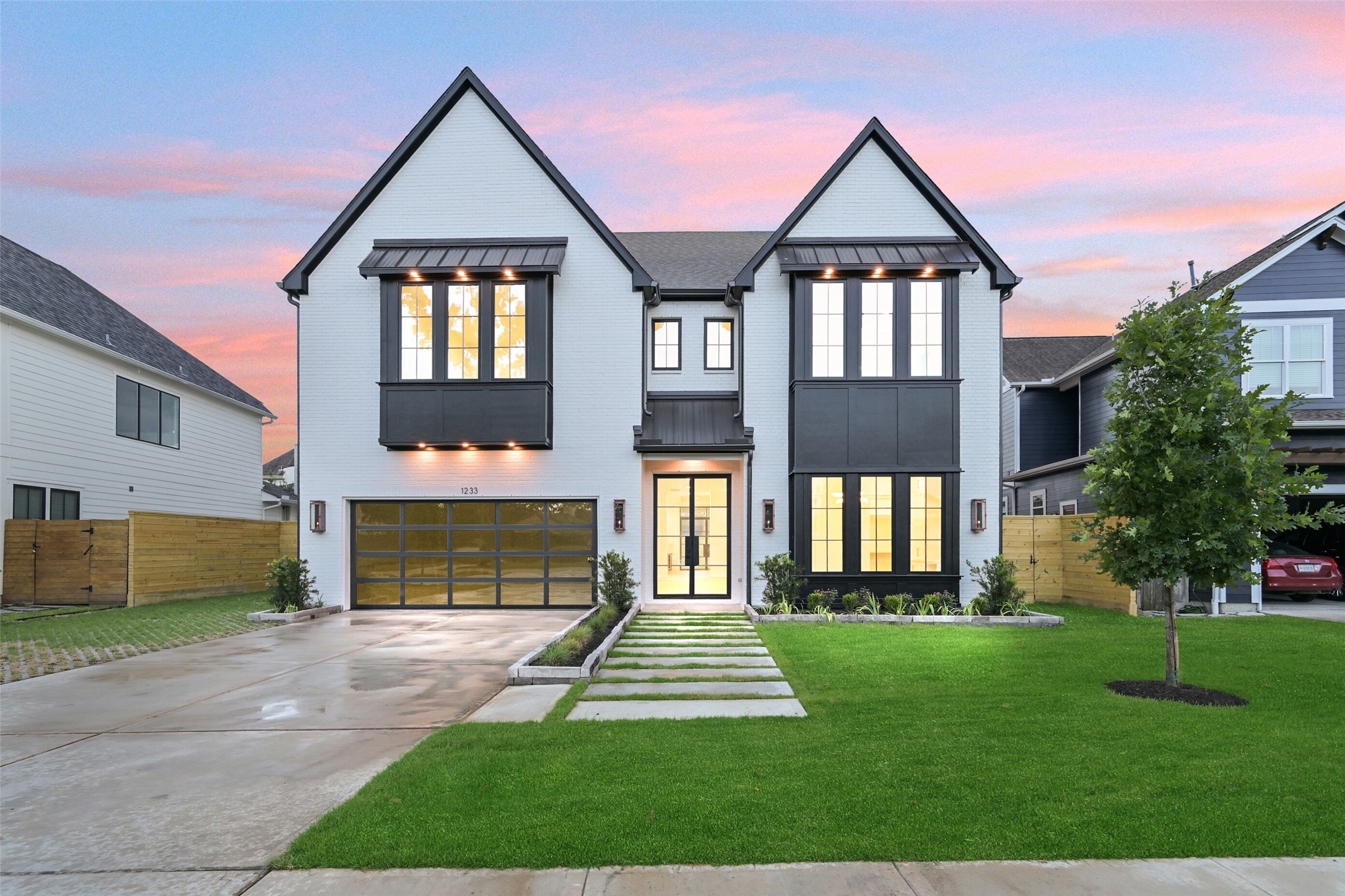 a front view of a house with a yard and garden