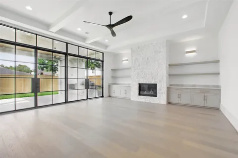 a large kitchen with a large counter top a sink stainless steel appliances and cabinets