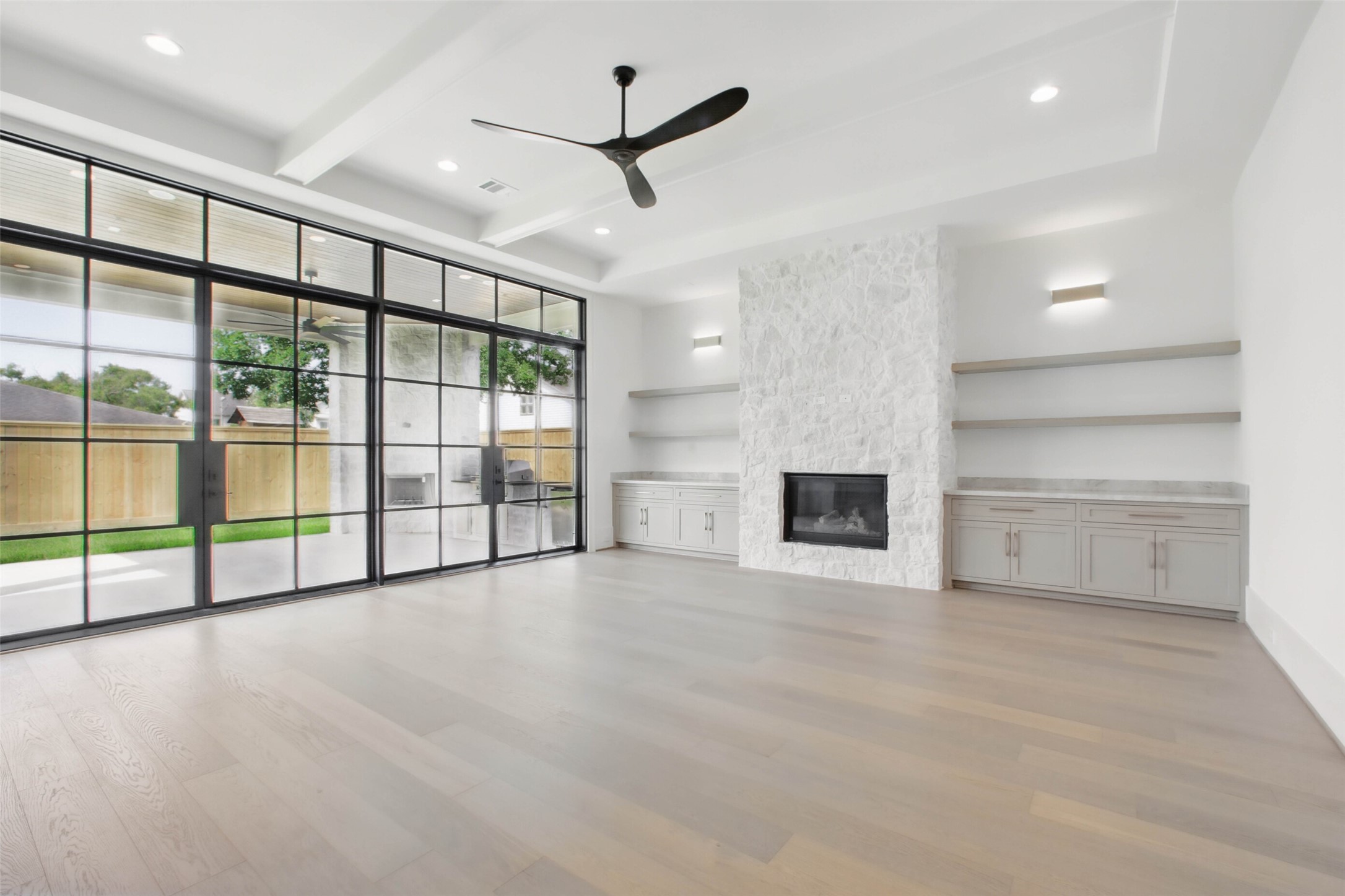 8619 Cedarbrake Drive Spring Valley Village, TX 77055 - Photo 9 of 31 an empty room with windows and a ceiling fan