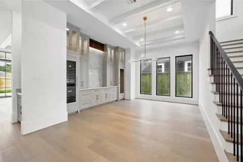 an empty room with windows and a ceiling fan