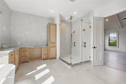 a spacious bathroom with double vanity sink a bathtub and window