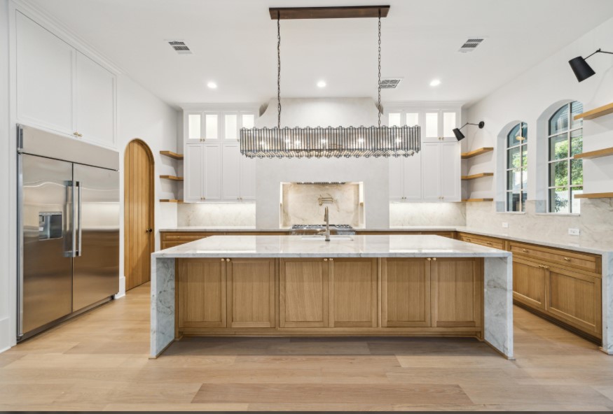 8619 Cedarbrake Drive Spring Valley Village, TX 77055 - Photo 7 of 31 a large kitchen with a large counter top a sink stainless steel appliances and cabinets