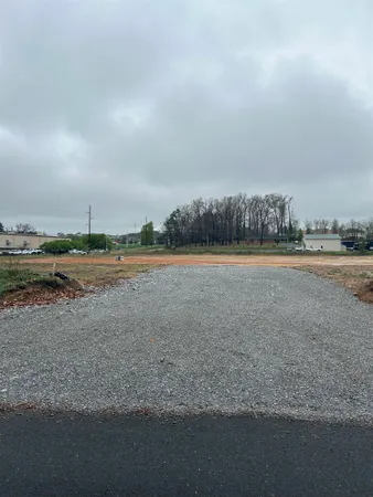 a view of a field with trees in background