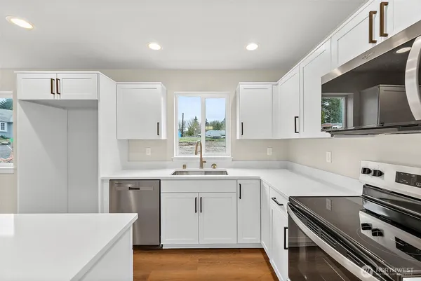 a kitchen with a sink stove and cabinets