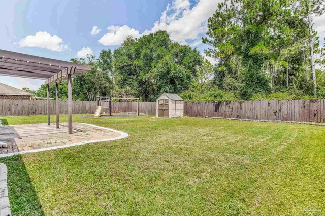a swimming pool with some trees in the background