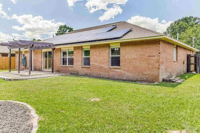 a front view of house with yard and outdoor seating
