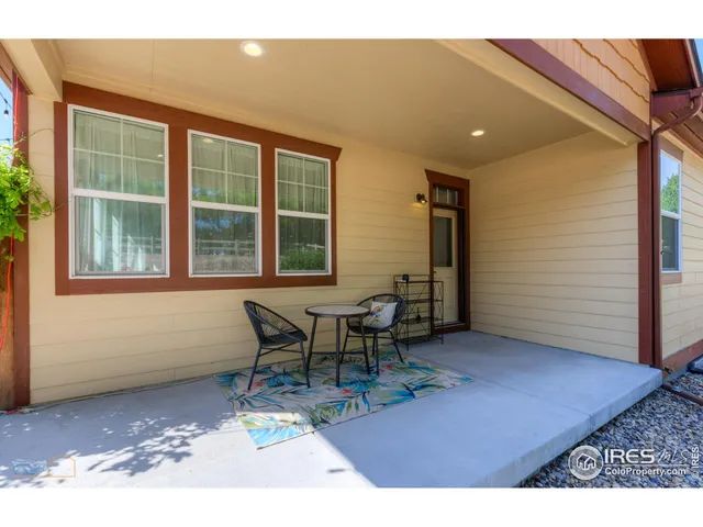 a bedroom with a bed and a view of living room