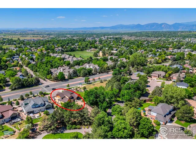 a view of a city with lush green forest