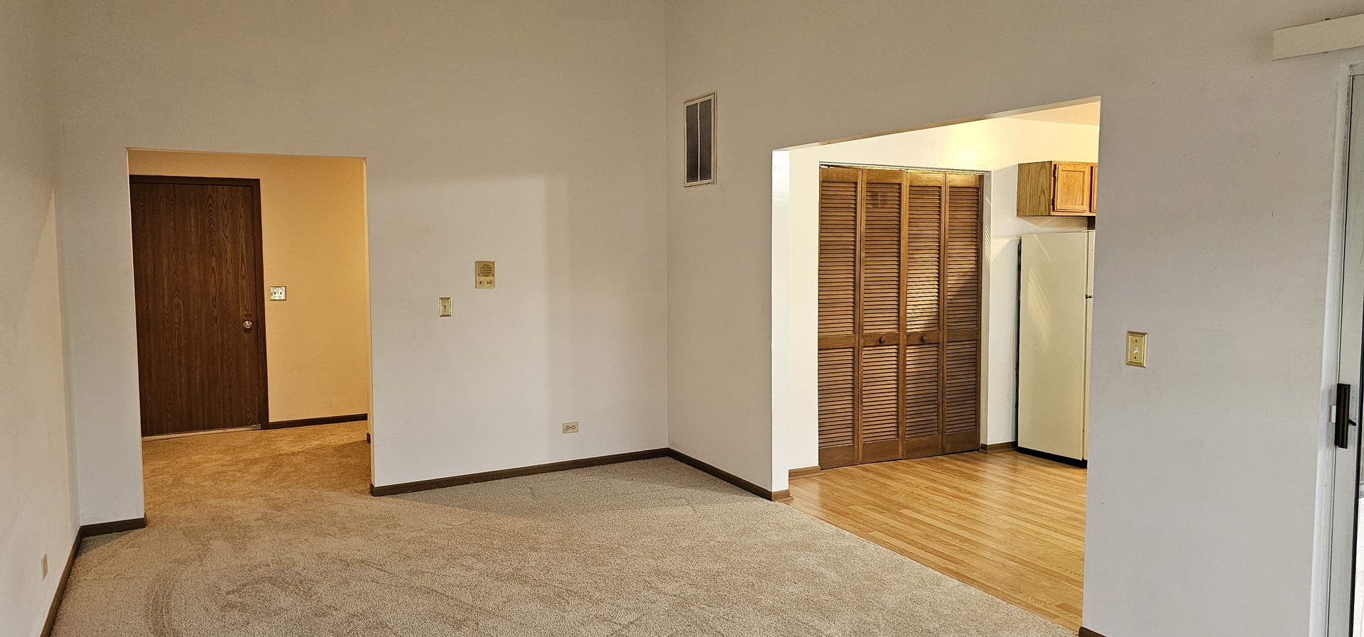 301 Village Creek Drive, Unit 2A Lake In The Hills, IL 60156 - Photo 12 of 31 a view of an empty room with wooden floor and a bathroom
