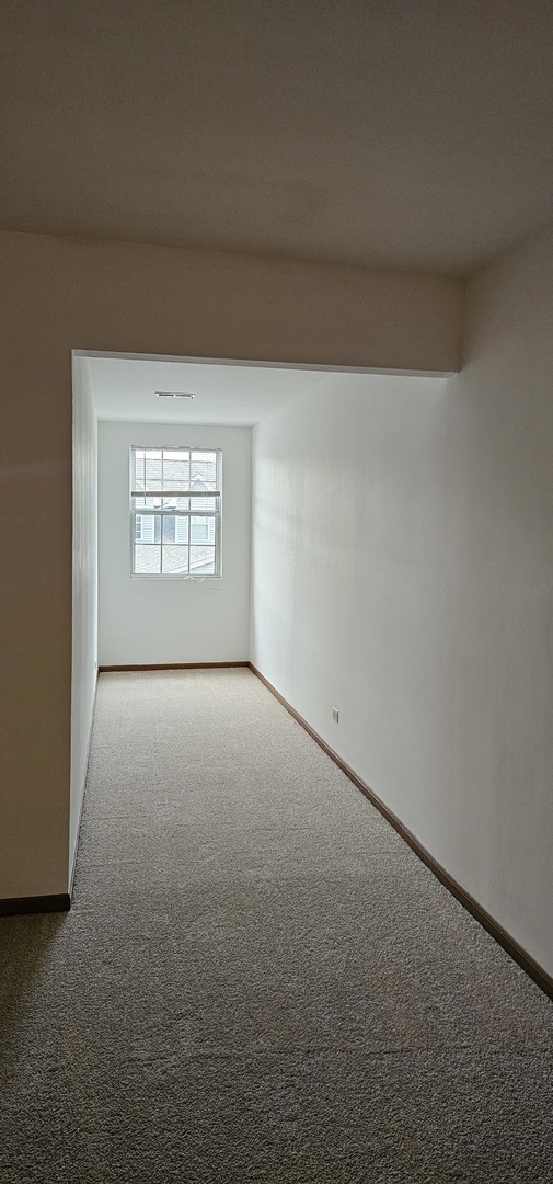 301 Village Creek Drive, Unit 2A Lake In The Hills, IL 60156 - Photo 20 of 31 an empty room with a window