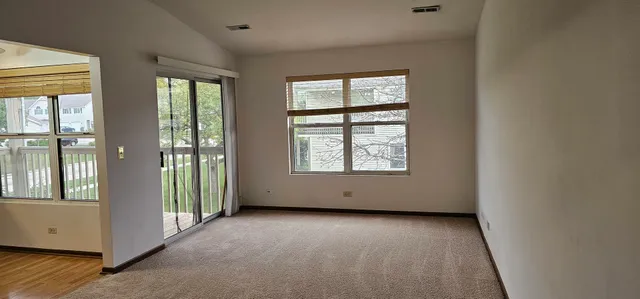 an empty room with windows and closet