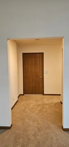 a view of a door of the house and a window