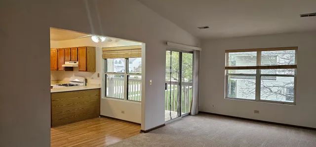 an empty room with large windows