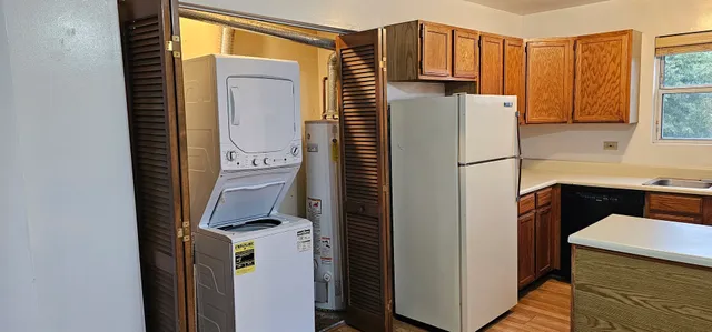 a kitchen with a refrigerator and a stove