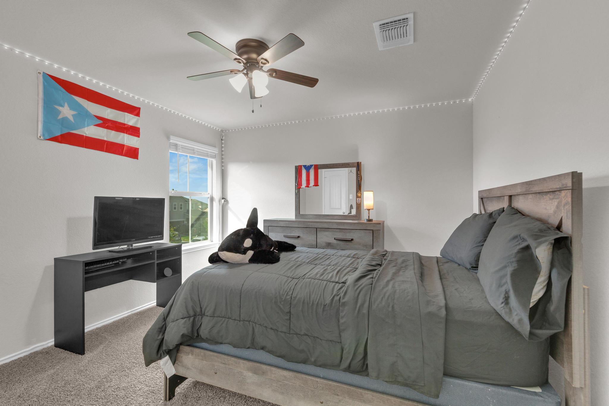 104 Uncle Billy Way Jarrell, TX 76537 - Photo 26 of 38 Well-lit sleeping quarters with a ceiling fan, plush carpeting, and a window for natural light.