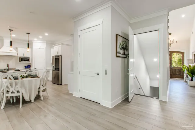 a living room with furniture kitchen view and a flat screen tv