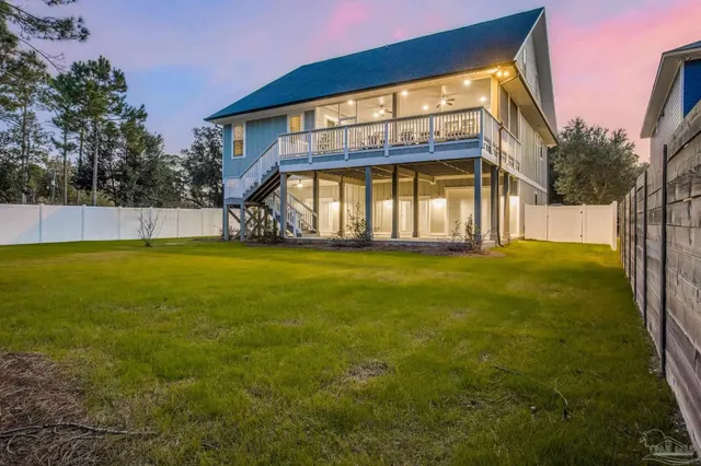 a view of a big yard with large trees and plants