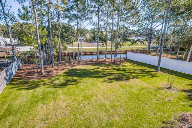 a view of a balcony with chairs and wooden floor