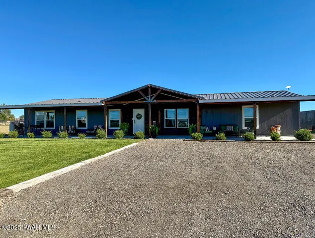 a front view of a house with a yard and porch