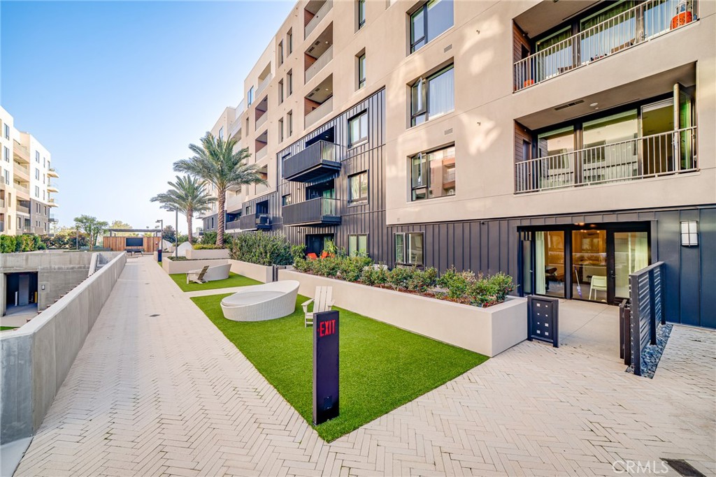 2202 Rivington Irvine, CA 92612 - Photo 17 of 21 a view of a house with many windows and plants